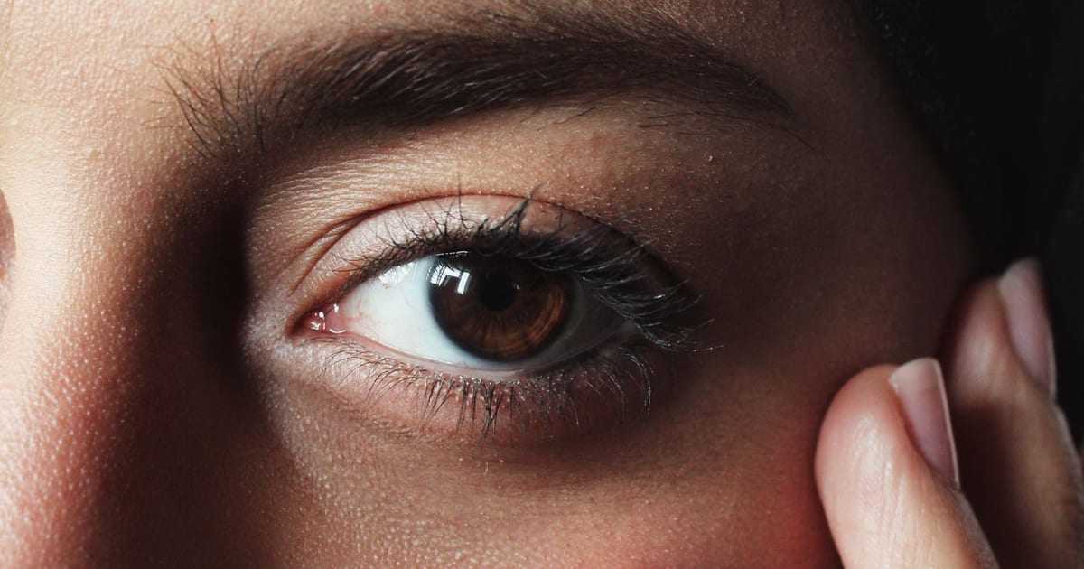 Close-up of a person's eye and cheek, focus on skin